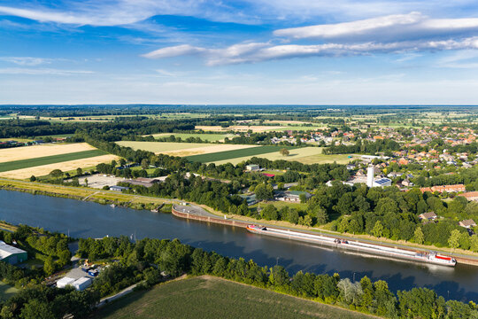 Travel and logistics. Kiel canal aerial footage. Cargo ship passing through canal in Germany. Transport logistics. Canal aerial view. Maritime transport