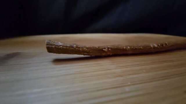 Organic Salvadora persica miswak stick, natural herbal toothbrush for dental hygiene and oral care, traditional eco-friendly wooden twig root on wood background.