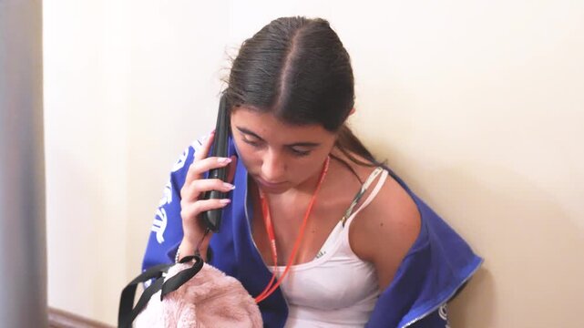 Girl enjoying interactive museum experience by following audio guide explanations during visit