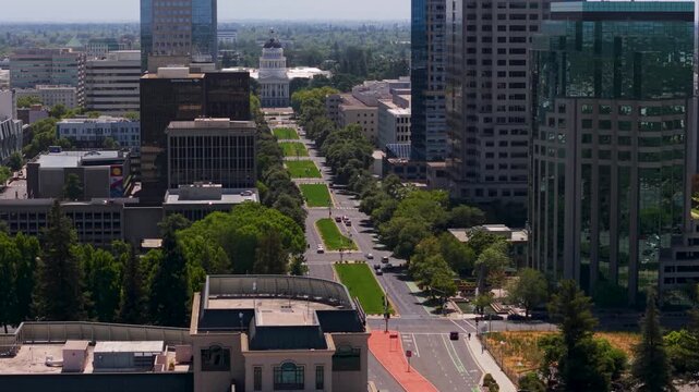 Explore aerial views showing California State Capitol and skyline from Tower Bridge in Sacramento with city streets and trees below