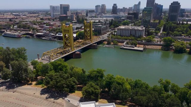 Aerial shots show Tower Bridge in Sacramento with capitol and downtown skyline visible in the background on a sunny day