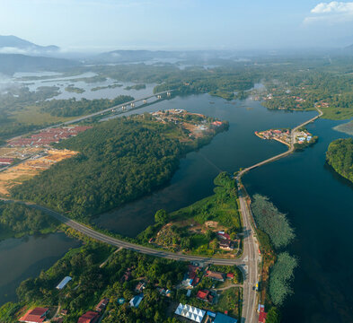 Aerial drone view of rural settlements by a lakeside scenery at Tasik Raban or Raban Lake in Lenggong, Perak, Malaysia