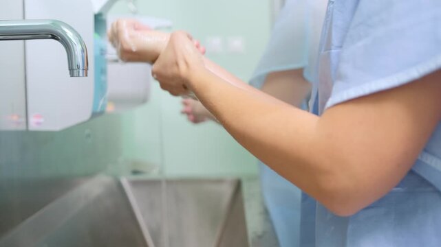 Hygiene in Practice: Close-up of a healthcare professional meticulously washing their hands under a running tap, emphasizing the crucial practice of hygiene and sanitation in a medical setting.