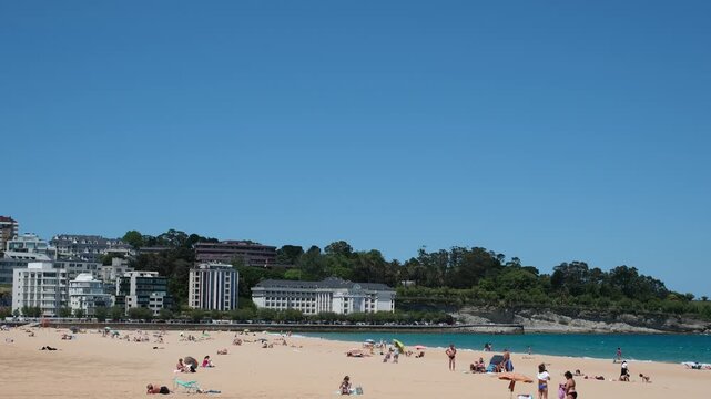 Santander, Cantabria, Spain. June 11, 2026. High tourist quality of the beach Playa Primera de El Sardinero. Golden sand, moderate waves, classic promenade.