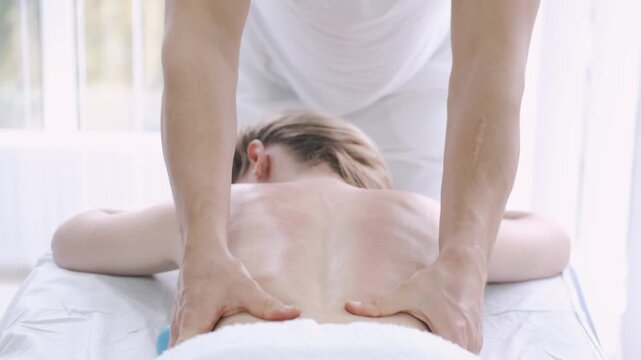having back and leg  massage by 2 men using 4 hands focusing on the muscles lubing there hands 