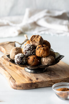 A pile of fresh homemade energy balls with a bite out of the one on top.