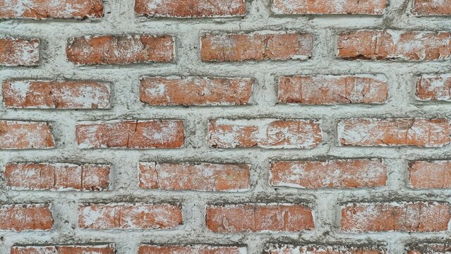 Vintage weathered brick wall background. Old orange brickwork texture with cement lines for architectural design.