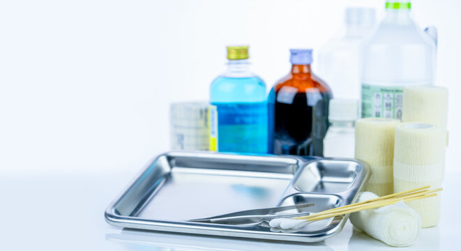 Medical equipment for treating infections. Wound care dressing set. Medical supplies for nurses. Conform bandage, forceps, cotton stick, alcohol. Sterile dressing materials. Healthcare equipment.