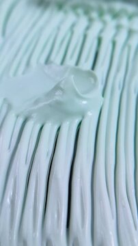 Top view process of smoothing wavy cream into an even flat layer. Beauty cream product presentation for thickness and viscosity concept.