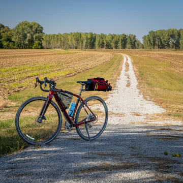 gravel touring bike on Steamboat Trace Trail converted from old railroad running across farmland and corn field near Peru, Nebraska
