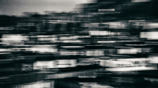Abstract motion blur city street scene in black and white, urban night lights, fast speed travel background texture