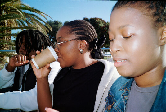 Friends having hot drinks outside