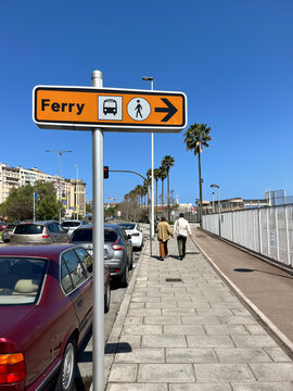 Walking to ferry on sunny Santander promenade