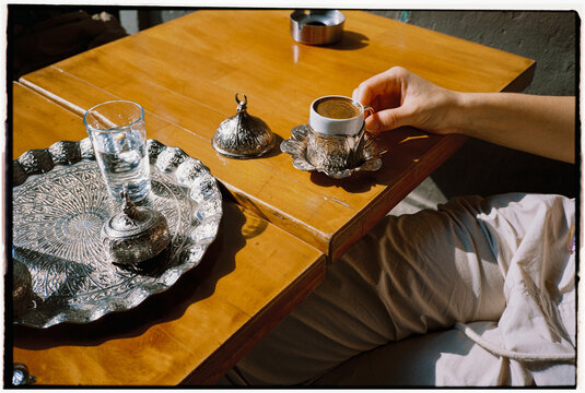 Person takes a cup of Turkish coffee 