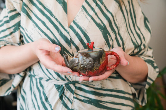 Holding a Unique Teapot During a Tea Ceremony