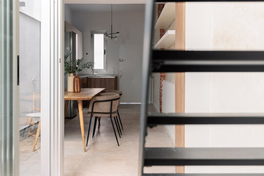 Dining Glimpsed Past Stairs