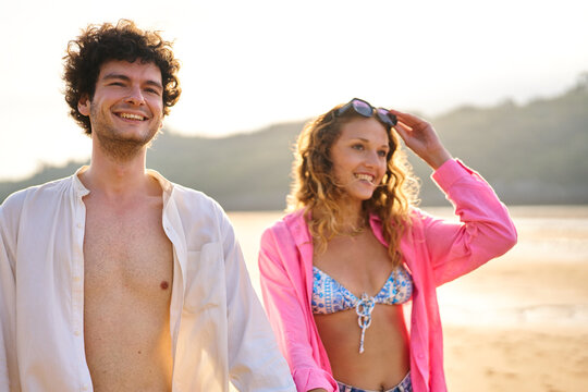 Happy young couple enjoying summer vacation on beach