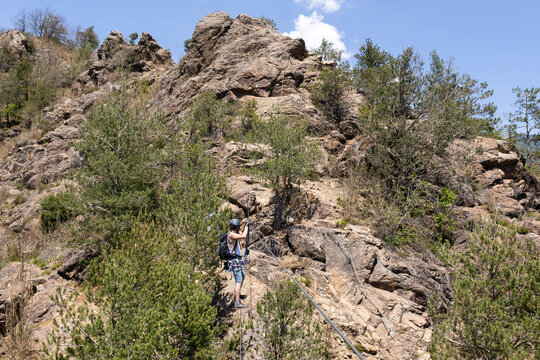 Climber Ascending Rocky Ferrata Route