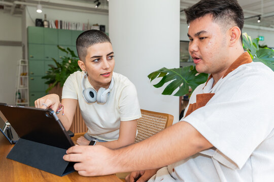 Young Colleagues Collaborating at a Table in a Bright Space