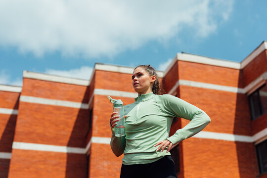Woman Drinking Water after Running