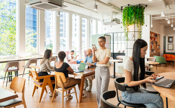 Busy Coworking Space With People Working and Interacting