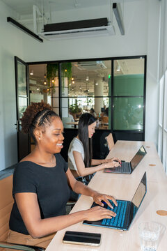 Women Working on Laptops in a Modern Office Space During Daytime