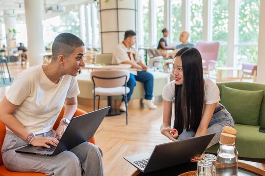 Colleagues Working on Laptops in a Modern Co-Working Space