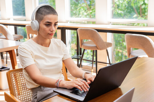 Digital Nomad Working on Laptop in Cafe During Daytime Hours