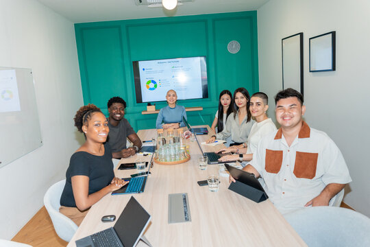 Team Members Gather for Discussion in a Conference Room Setting