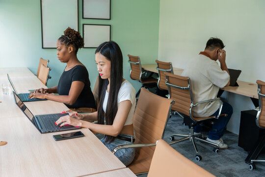 People Working on Laptops in a Modern Office Space