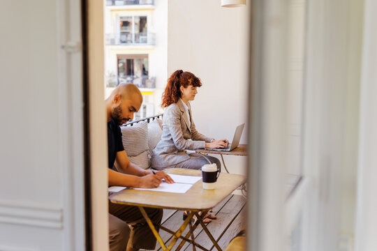 People working remotely on a balcony