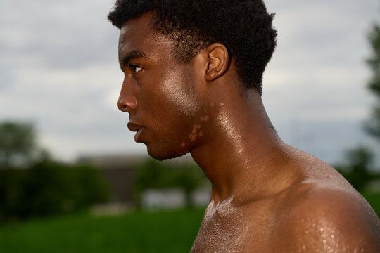 Young Man Stands With Focus in Outdoor Setting During Day