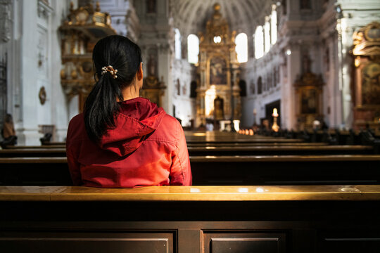 Munich Church Interior with Visitor in Prayer