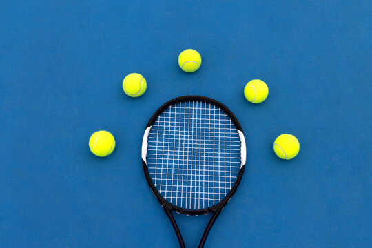 Tennis Racket with Five Balls on Blue Court