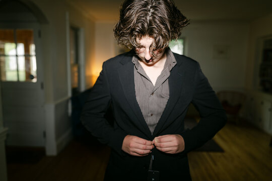 teen boy trying on a new suit 