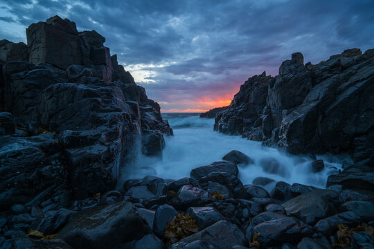 Waves down a channel at sunrise