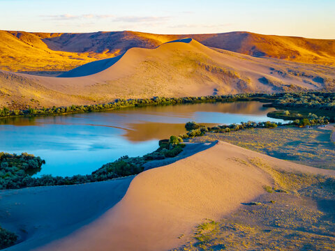 Panoramic sunset view of dunes and lake at Bruneau State Park