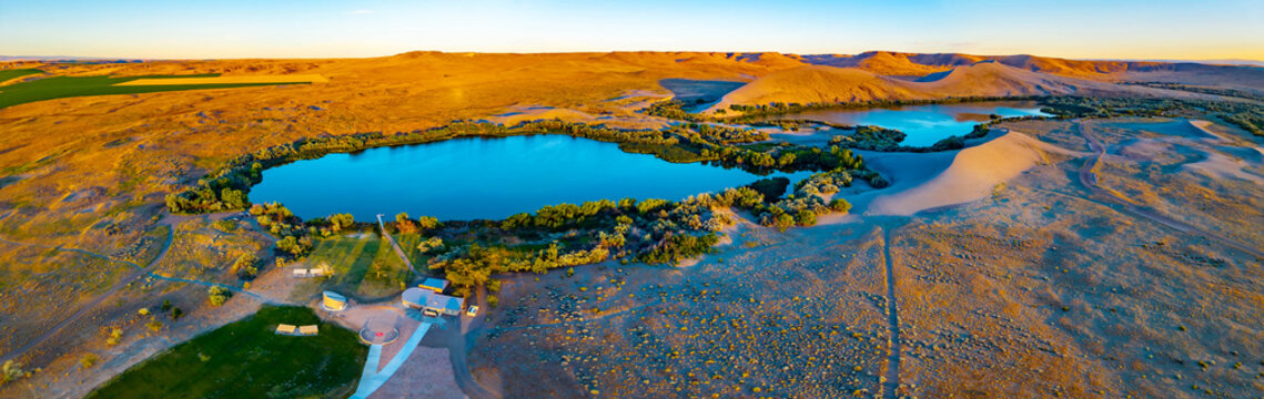 Panoramic sunset view of dunes and lake at Bruneau State Park