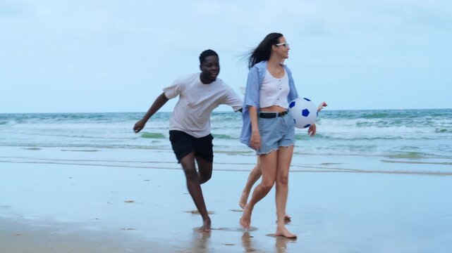 A carefree group of young adults jogging on the beach, representing freedom, vitality, and an active unplugged lifestyle away from the city.