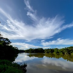 Obraz premium Serene lake with lush greenery and dramatic sky.