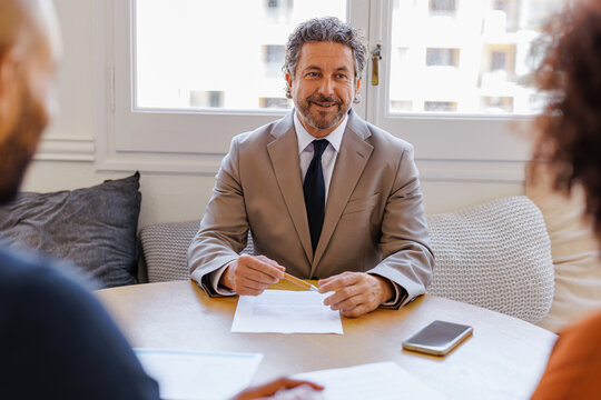 Financial advisor smiling during consultation meeting with clients