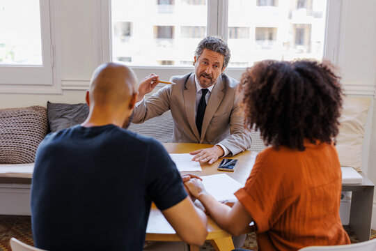 Financial advisor consulting clients about financial planning