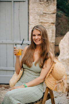 Young woman enjoying refreshing summer drink on holiday