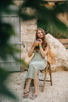 Young woman enjoying summer holiday with refreshing drink