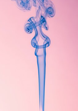 Wisps of ethereal blue smoke curl gracefully against a soft, rosy pink gradient background, creating a dreamy and abstract visual effect, isolated, smooth, calm