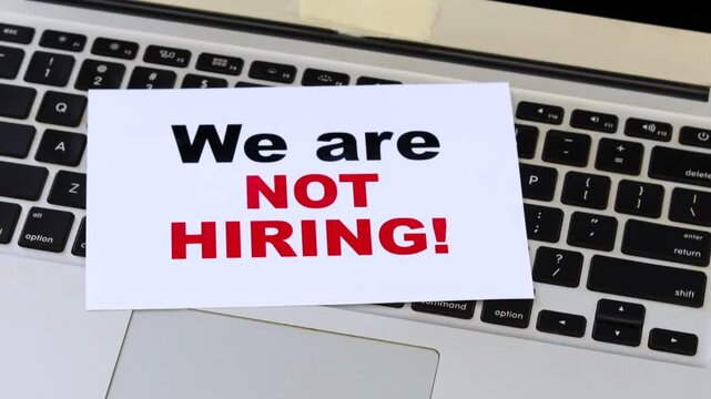 We Are Not Hiring Sign on Laptop Keyboard &ndash; Recruitment Freeze, Job Market Slowdown and Business Downsizing Concept