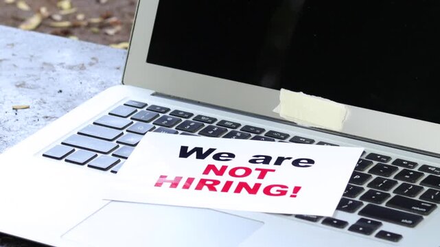 We Are Not Hiring Sign on Laptop Keyboard &ndash; Recruitment Freeze, Job Market Slowdown and Business Downsizing Concept