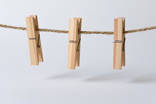 The Wooden Clothespins on a Rope in Minimal Studio Setting