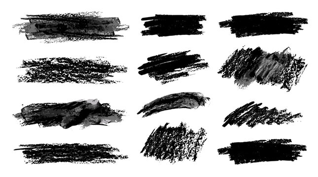 Collection of black brush strokes and smudges with textured appearance