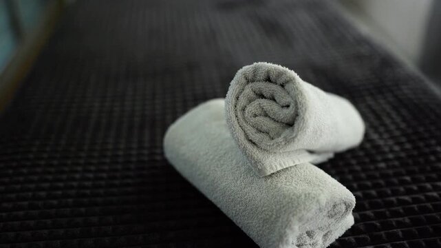 A massage parlor atmosphere for relaxation and well-being. A cozy, quiet room with a couch and towels for rest and recharge.